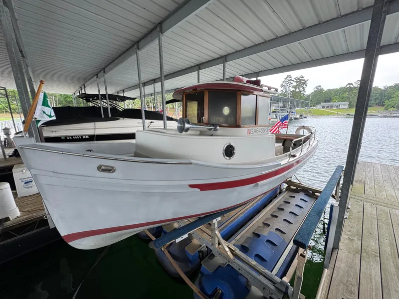 Slide: The Image of 1990 Ranger Tugs R21 Classic boat docked under a covered marina. - 26