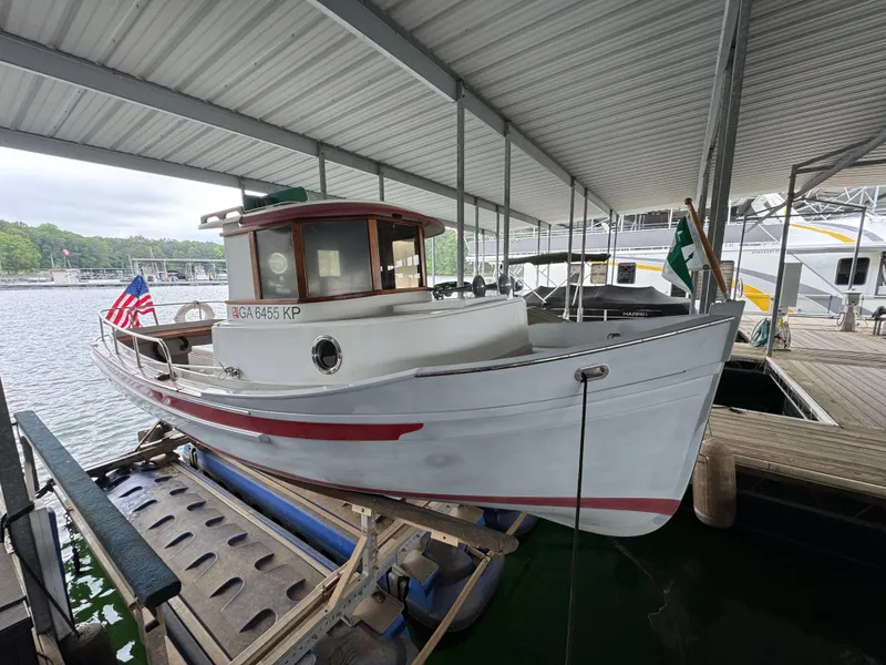 Slide: The Image of 1990 Ranger Tugs R21 Classic boat docked under a covered marina. - 27