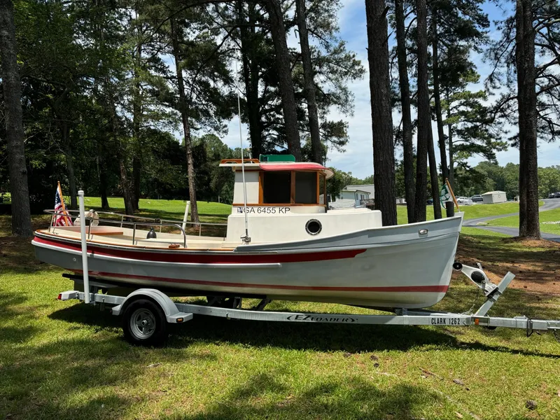 Slide: The Image of 1990 Ranger Tugs R21 Classic boat on trailer in wooded area. - 4