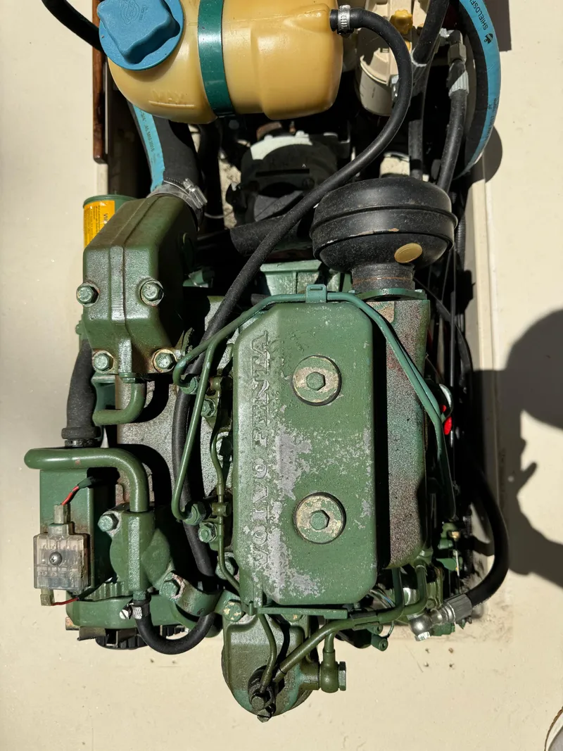 Slide: The Image of 1990 Ranger Tugs R21 Classic engine, detailed view, green components, hoses, and wiring. - 6