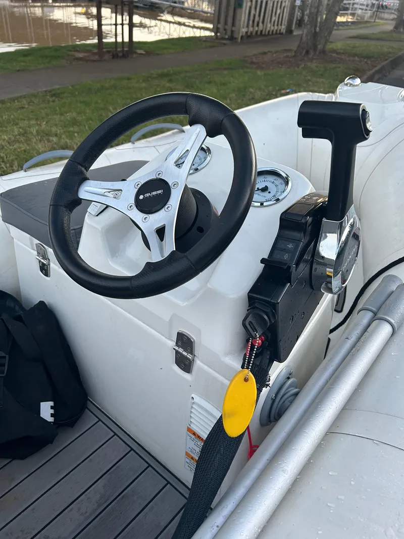 Slide: The Image of 2022 Brig Falcon Tender 300 boat steering console with controls and gauges. - 19