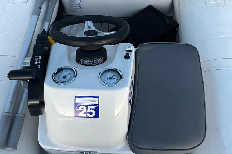 Slide: The Image of 2022 Brig Falcon Tender 300 boat console with steering wheel and gauges. - 21