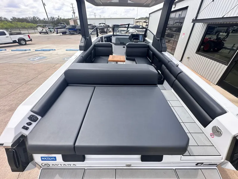 Slide: The Image of 2024 Aviara AV28 boat with spacious seating and modern design at a marina. - 10