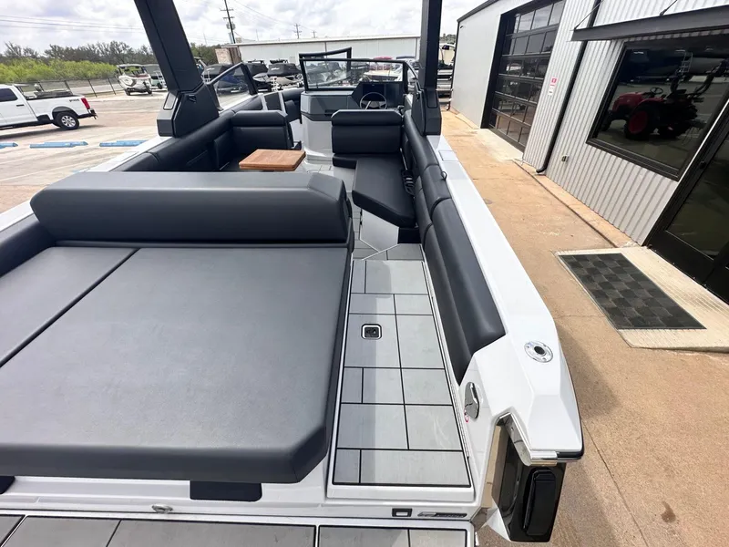 Slide: The Image of 2024 Aviara AV28 boat with sleek seating and modern design at a marina. - 12