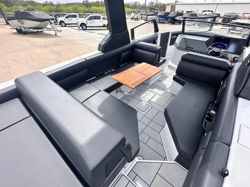 Slide: The Image of 2024 Aviara AV28 boat interior with sleek seating and modern design at a marina. - 13