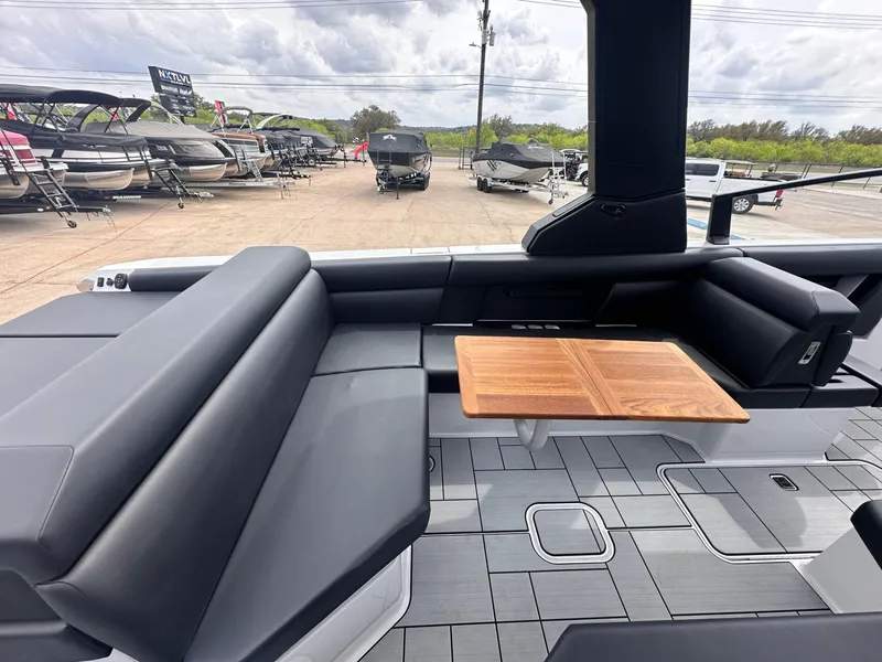 Slide: The Image of 2024 Aviara AV28 boat interior with sleek seating and wooden table. - 14