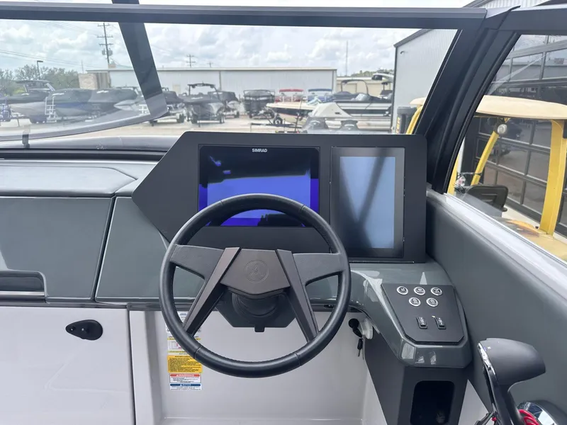 Slide: The Image of 2024 Aviara AV28 helm with Simrad display and modern controls. - 18