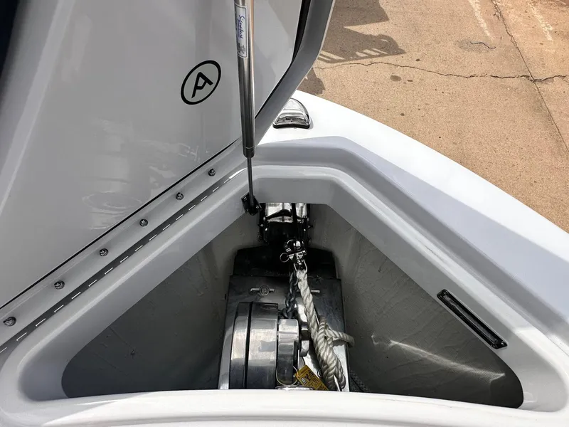 Slide: The Image of 2024 Aviara AV28 boat anchor compartment with hydraulic lift and rope storage. - 28