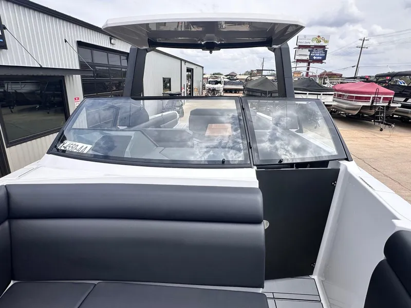 Slide: The Image of 2024 Aviara AV28 boat with sleek design, spacious seating, and modern features at a marina. - 29