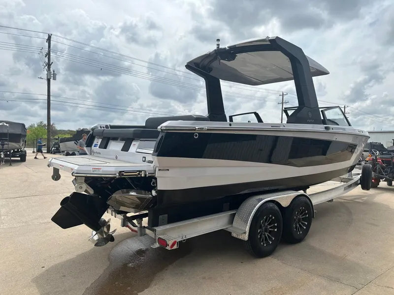 Slide: The Image of 2024 Aviara AV28 boat on trailer under cloudy sky. - 4