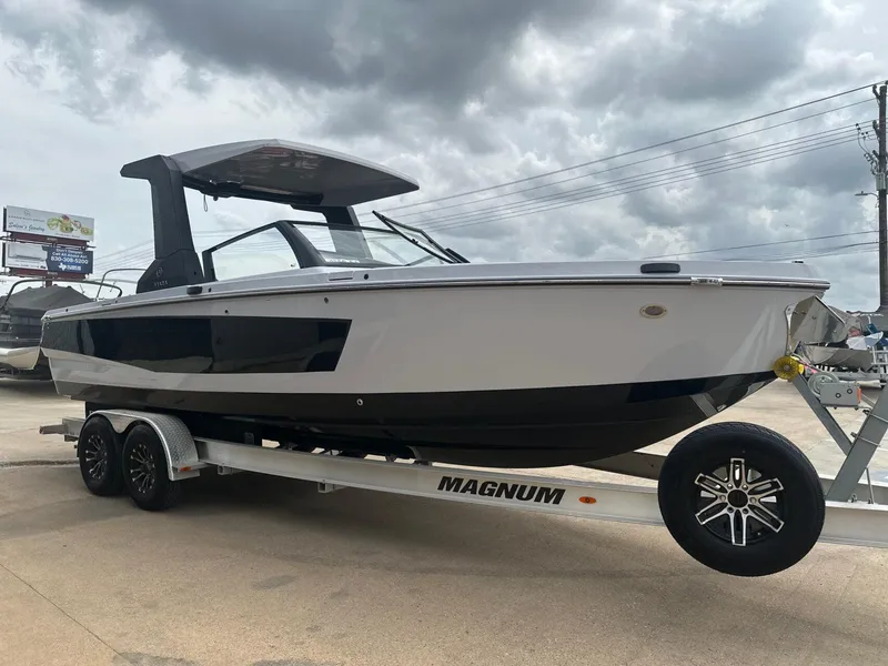 Slide: The Image of 2024 Aviara AV28 boat on trailer under cloudy sky. - 6