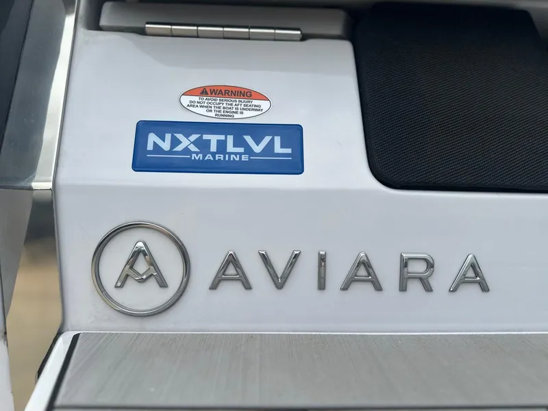 Slide: The Image of 2024 Aviara AV28 boat branding with NXT LVL Marine logo and warning label. - 9