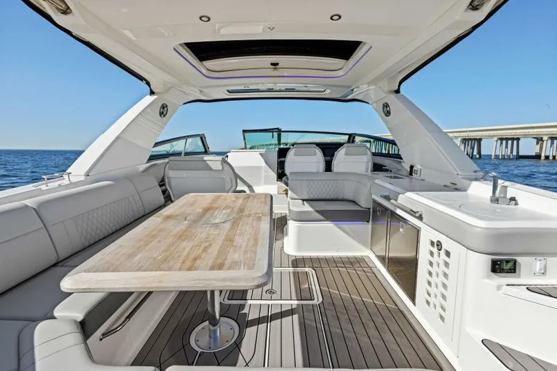 Slide: The Image of Luxurious 2023 Sea Ray SLX 400 OB yacht interior with seating and table, ocean view. - 11
