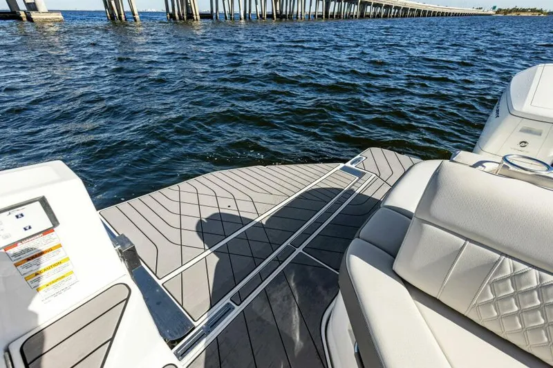 Slide: The Image of 2023 Sea Ray SLX 400 OB boat deck with water and bridge view. - 12