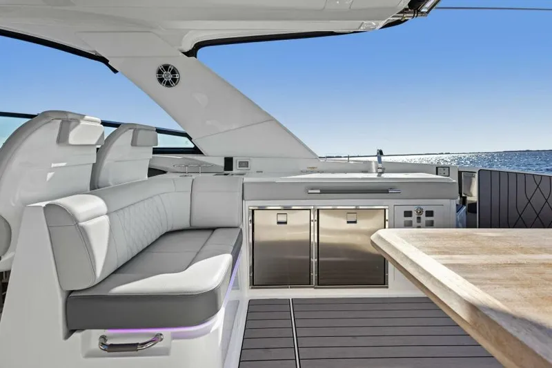 Slide: The Image of 2023 Sea Ray SLX 400 OB luxury yacht interior with seating and kitchenette. - 14