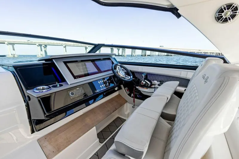 Slide: The Image of 2023 Sea Ray SLX 400 OB helm with modern controls and luxurious seating. - 16