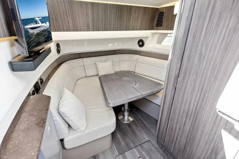 Slide: The Image of Luxurious interior of 2023 Sea Ray SLX 400 OB with modern seating and table. - 29