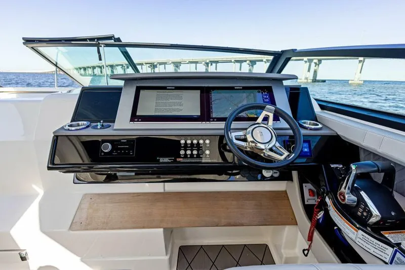 Slide: The Image of 2023 Sea Ray SLX 400 OB helm with modern controls and ocean view. - 3