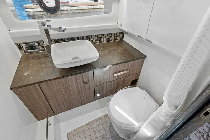 Slide: The Image of Luxurious bathroom in 2023 Sea Ray SLX 400 OB boat with modern sink and toilet. - 31