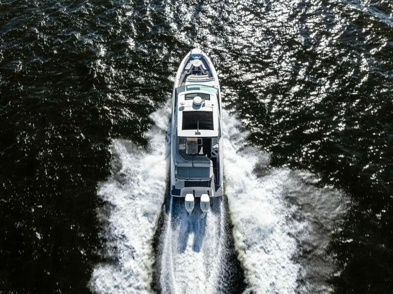 Slide: The Image of 2023 Sea Ray SLX 400 OB cruising on open water, aerial view. - 38