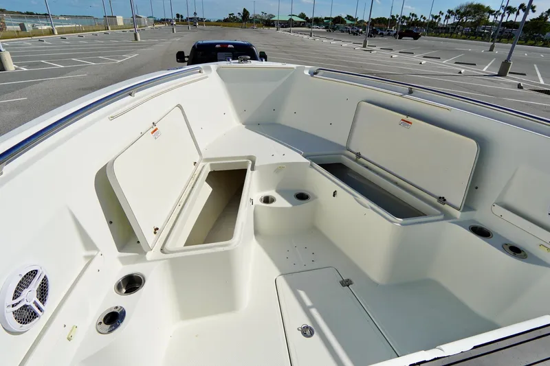 Slide: The Image of 2009 Sailfish 2860 CC boat interior with open storage compartments in a parking lot. - 12