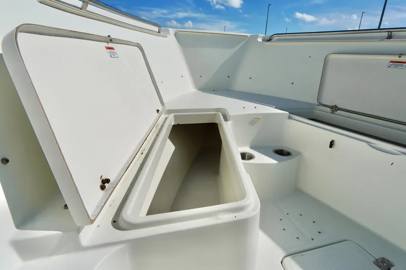 Slide: The Image of 2009 Sailfish 2860 CC boat interior with open storage compartment and cup holders. - 13