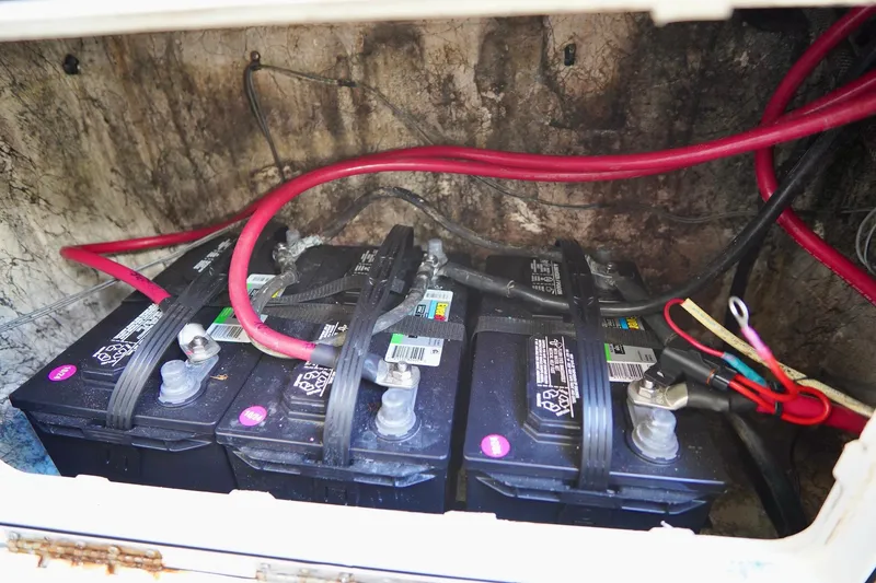 Slide: The Image of Three marine batteries with red cables in a 2009 Sailfish 2860 CC boat. - 22