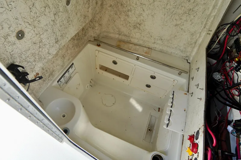 Slide: The Image of 2009 Sailfish 2860 CC boat interior with storage compartments and wiring. - 24