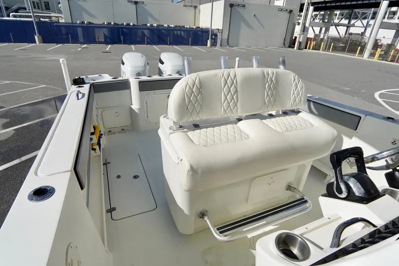 Slide: The Image of 2009 Sailfish 2860 CC boat interior with white seating and fishing rod holders. - 25