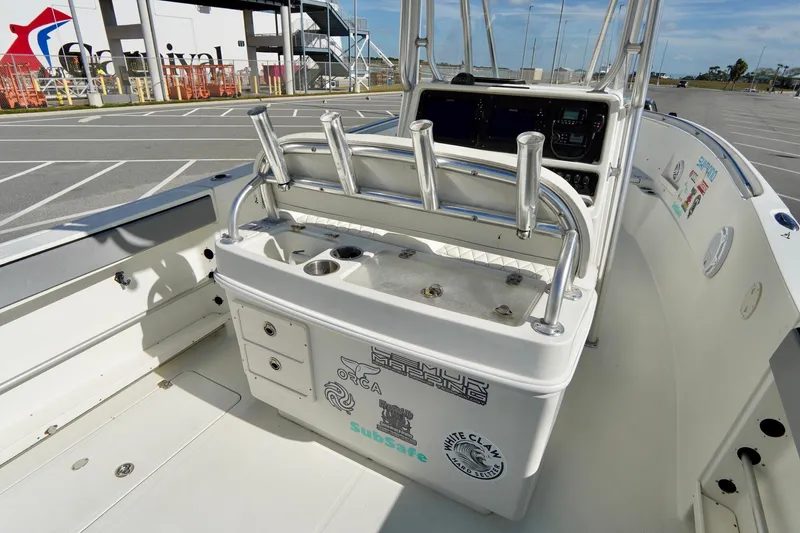 Slide: The Image of 2009 Sailfish 2860 CC boat interior with fishing rod holders and control panel. - 26
