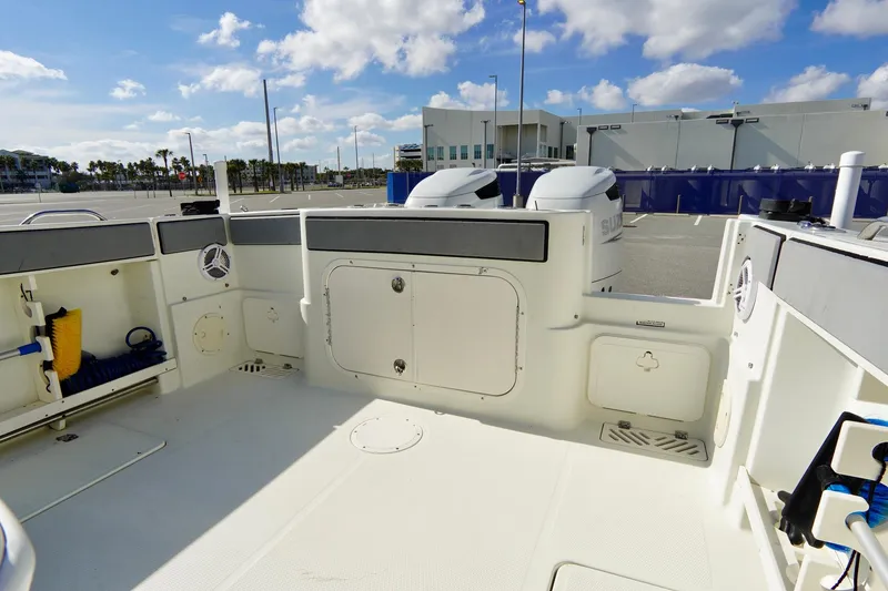 Slide: The Image of 2009 Sailfish 2860 CC boat interior with storage compartments and twin engines. - 30