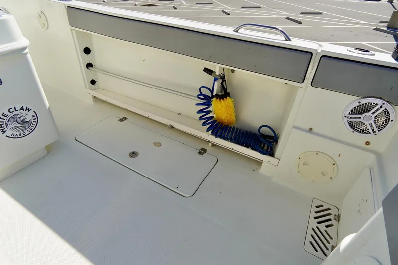 Slide: The Image of 2009 Sailfish 2860 CC boat deck with storage and cleaning equipment. - 31