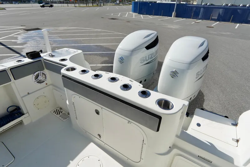 Slide: The Image of 2009 Sailfish 2860 CC boat with dual Suzuki outboard motors in a parking lot. - 33