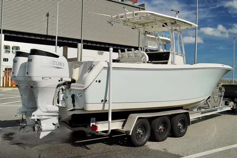 Slide: The Image of 2009 Sailfish 2860 CC boat on trailer with twin Suzuki outboard engines. - 36
