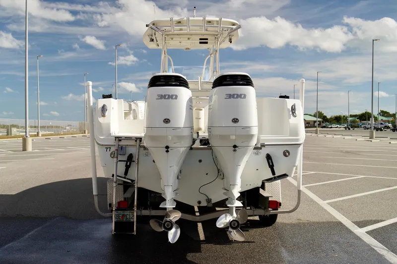 Slide: The Image of 2009 Sailfish 2860 CC boat with dual 300 horsepower engines in a parking lot. - 42
