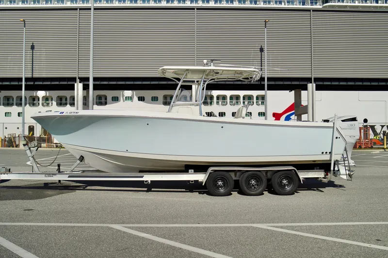 Slide: The Image of 2009 Sailfish 2860 CC boat on trailer, parked in urban setting. - 8