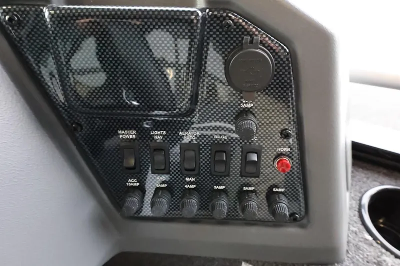 Slide: The Image of Control panel of 2025 Lowe Fish & Ski FS 1625 boat with switches and power outlets. - 14