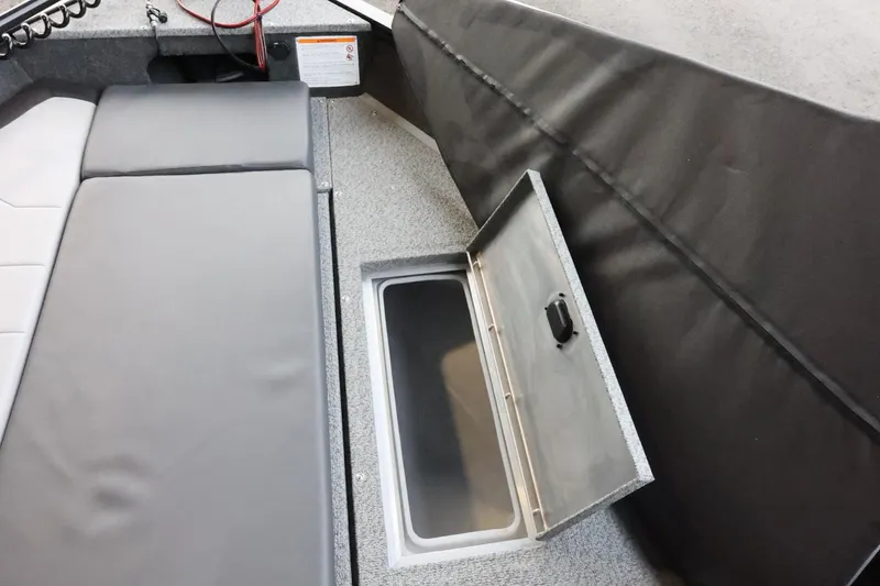 Slide: The Image of 2025 Lowe Fish & Ski FS 1625 boat interior with open storage compartment. - 17