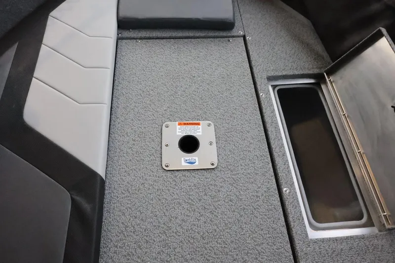 Slide: The Image of 2025 Lowe Fish & Ski FS 1625 boat interior with storage compartment and seat base. - 18