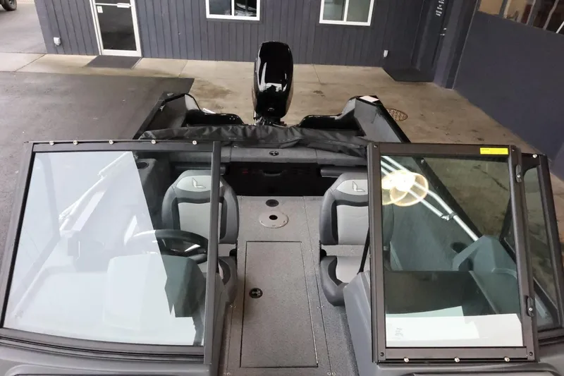 Slide: The Image of 2025 Lowe Fish & Ski FS 1625 boat interior with seating and windshield. - 21