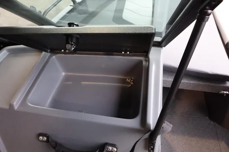 Slide: The Image of 2025 Lowe Fish & Ski FS 1625 boat storage compartment with open lid. - 24
