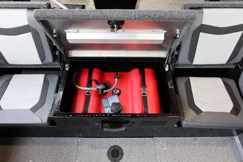 Slide: The Image of 2025 Lowe Fish & Ski FS 1625 boat storage compartment with red fuel tank. - 26