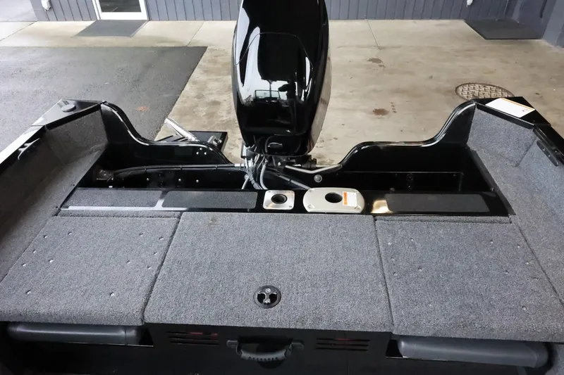 Slide: The Image of 2025 Lowe Fish & Ski FS 1625 boat interior with motor and storage compartments. - 29