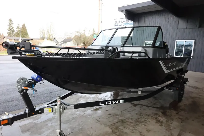 Slide: The Image of 2025 Lowe Fish & Ski FS 1625 boat on trailer, black exterior, parked outdoors. - 4