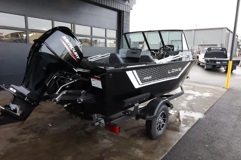 Slide: The Image of 2025 Lowe Fish & Ski FS 1625 boat with Mercury engine, parked outdoors. - 8