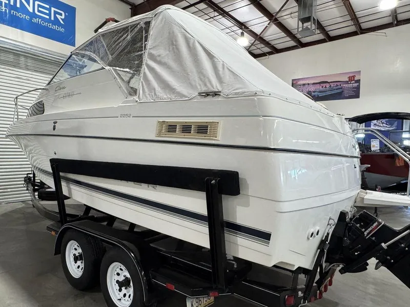 Slide: The Image of 2000 Bayliner 2252 Ciera Express boat on trailer in indoor showroom. - 11