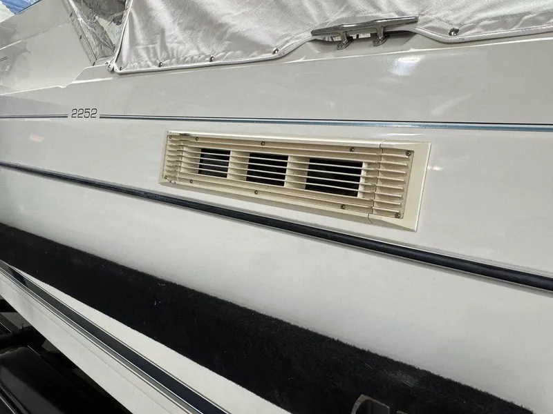 Slide: The Image of 2000 Bayliner 2252 Ciera Express boat side view with vent detail. - 13