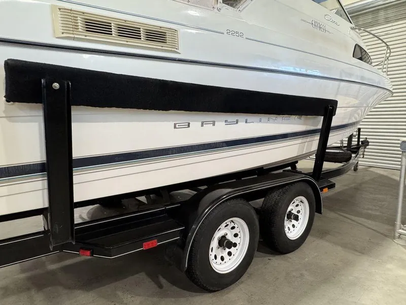 Slide: The Image of 2000 Bayliner 2252 Ciera Express on trailer in storage facility. - 25