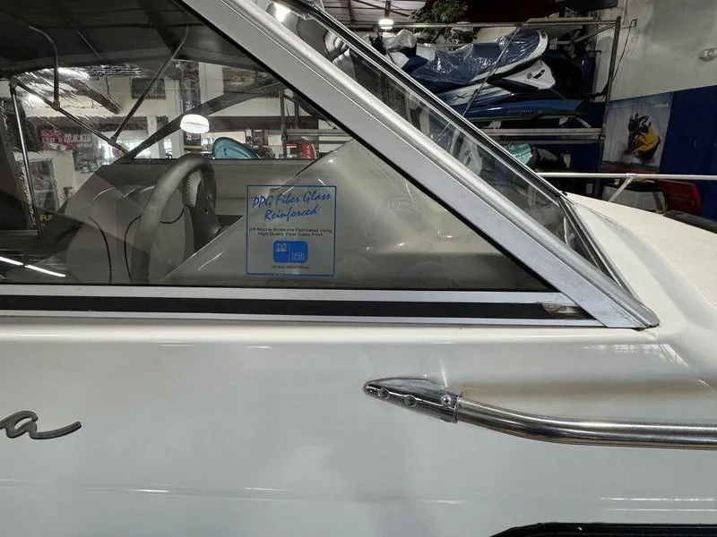 Slide: The Image of 2000 Bayliner 2252 Ciera Express boat side view in a showroom. - 33