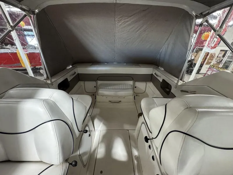 Slide: The Image of Interior of 2000 Bayliner 2252 Ciera Express boat with white seating and canopy. - 40